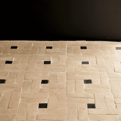 a tiled floor featuring clé zellige bejmat tiles in natural, installed in a basketweave variation pattern