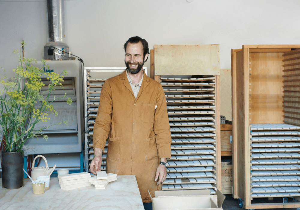 Eric Vandermolen stands in the clé guild studio with freshly fired tiles.