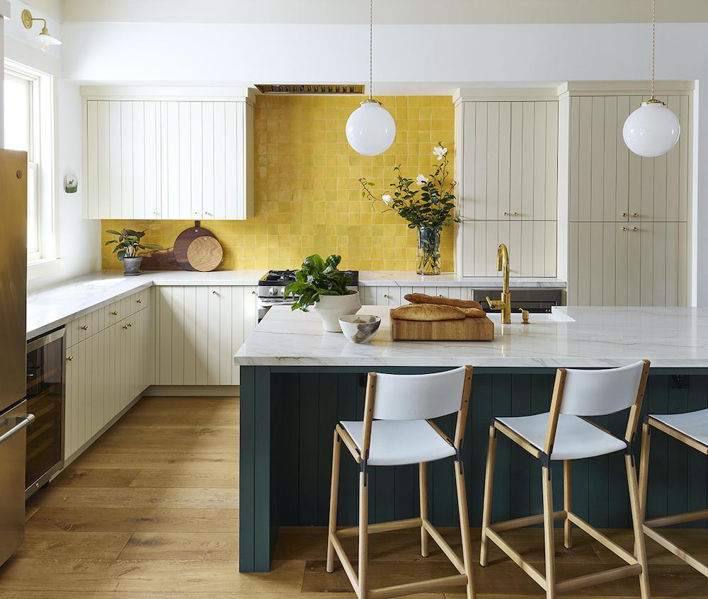 a bright kitchen with clé tile zellige 2x2 squares in Indian Saffron on the backsplash wall.