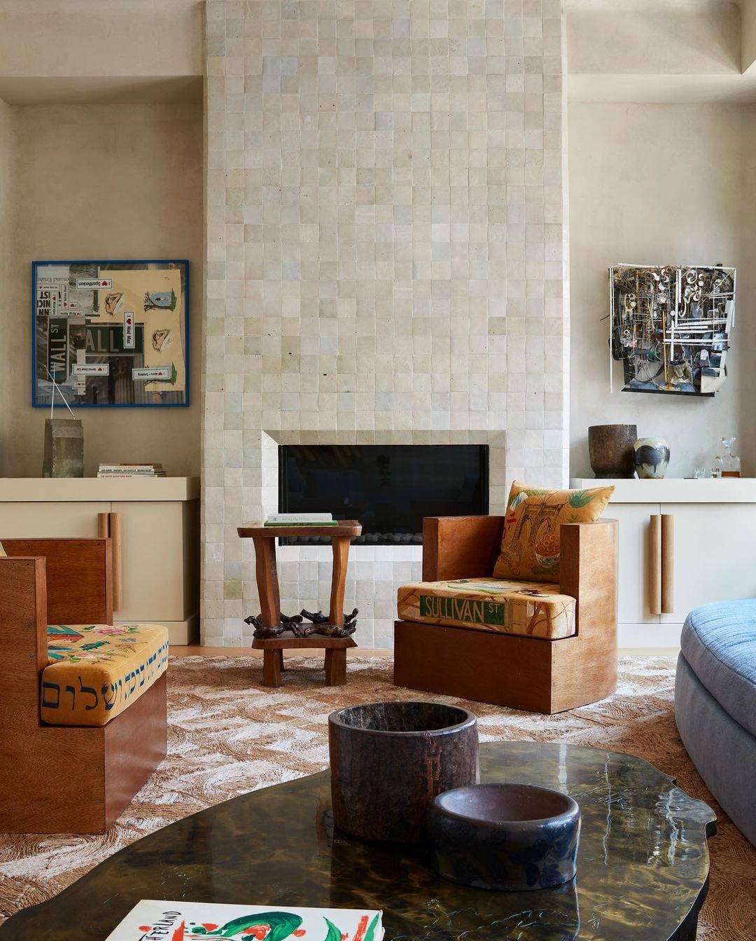 a living room with a fireplace tiled in clé tile zellige squares in weathered white.